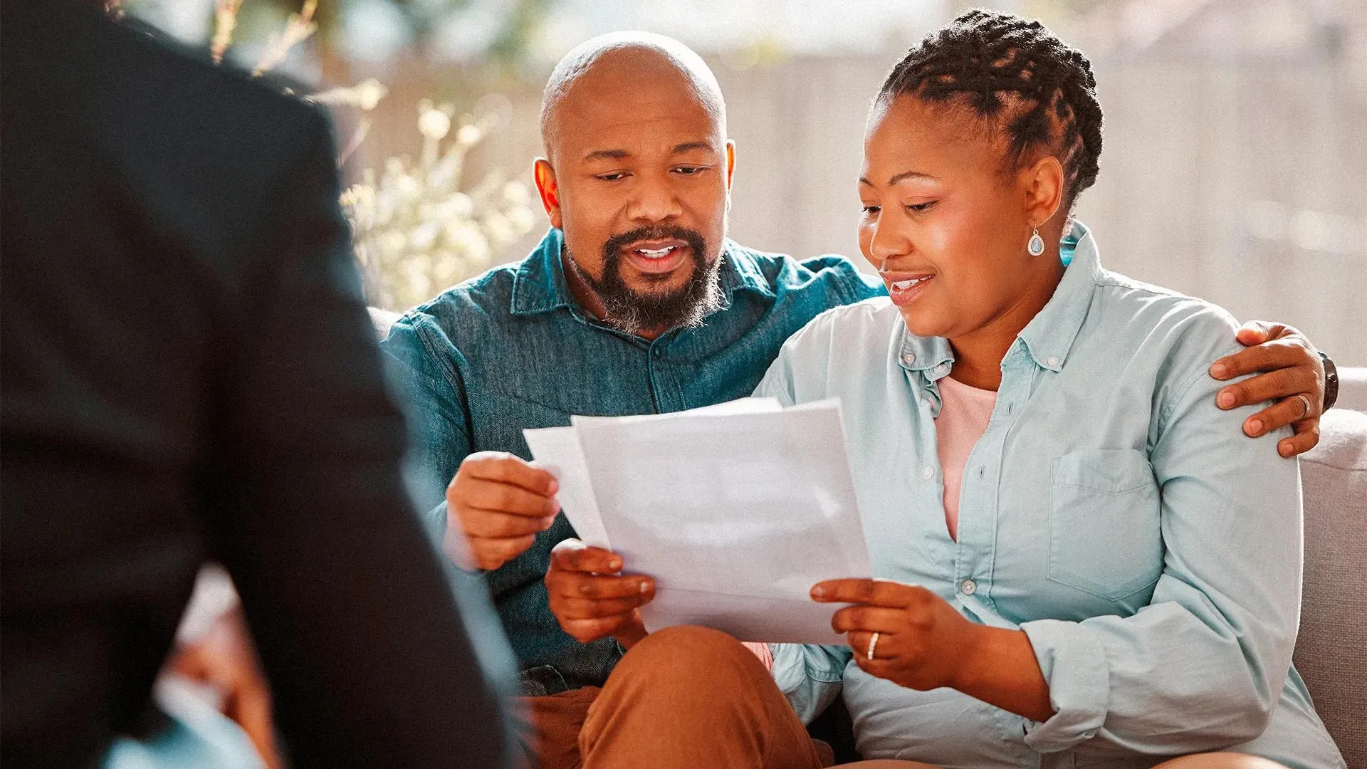 A couple reviewing their refinance savings at home
